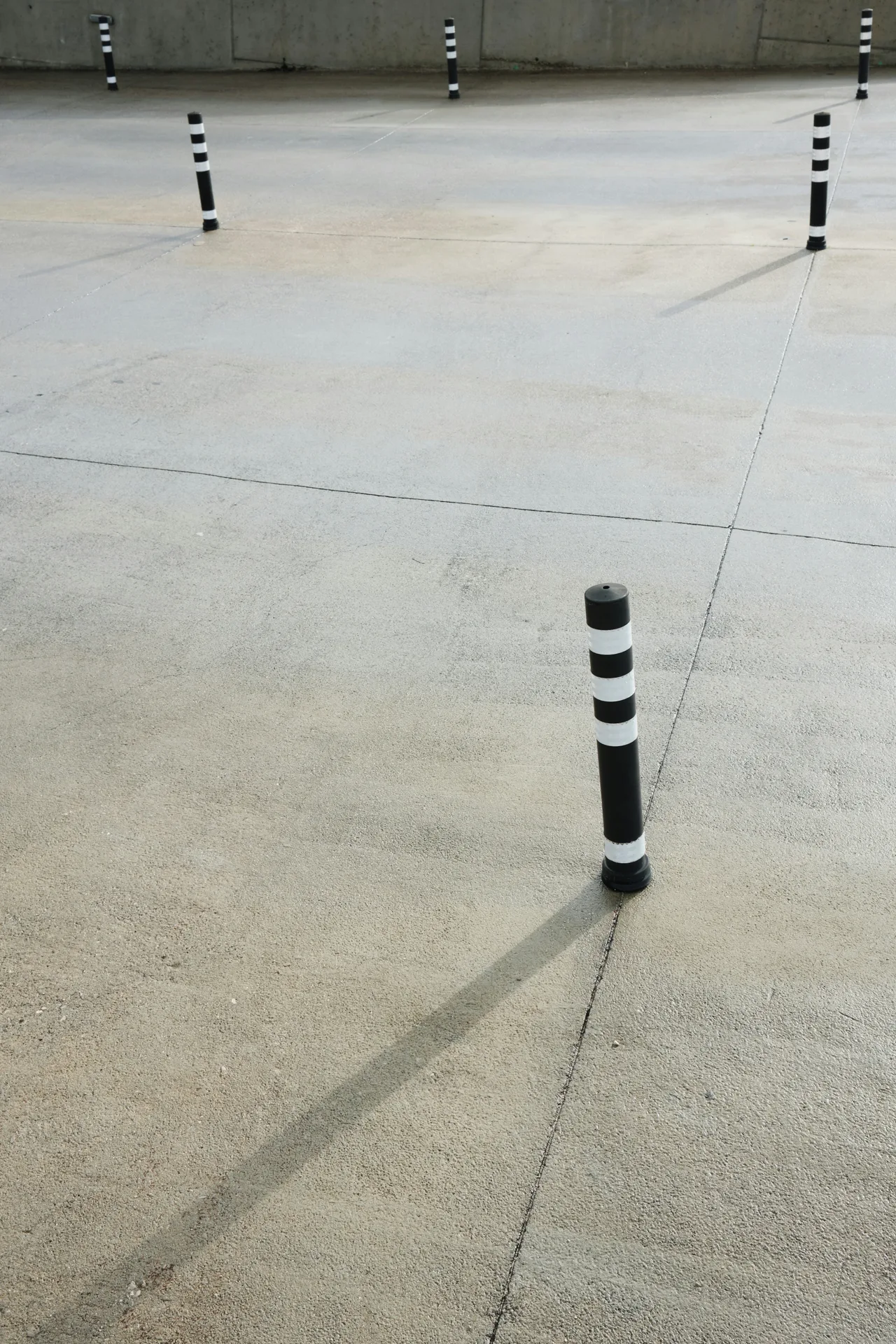 broom-finished concrete parking lot with bollards in Oshawa