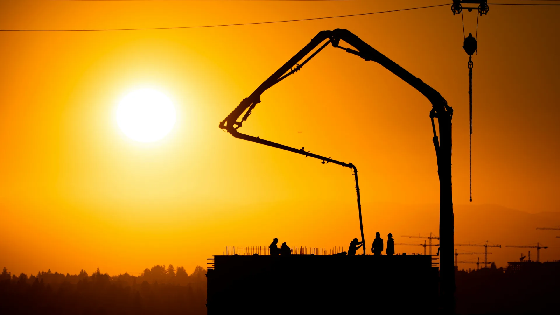 concrete boom pump on a Oshawa construction site at sunset