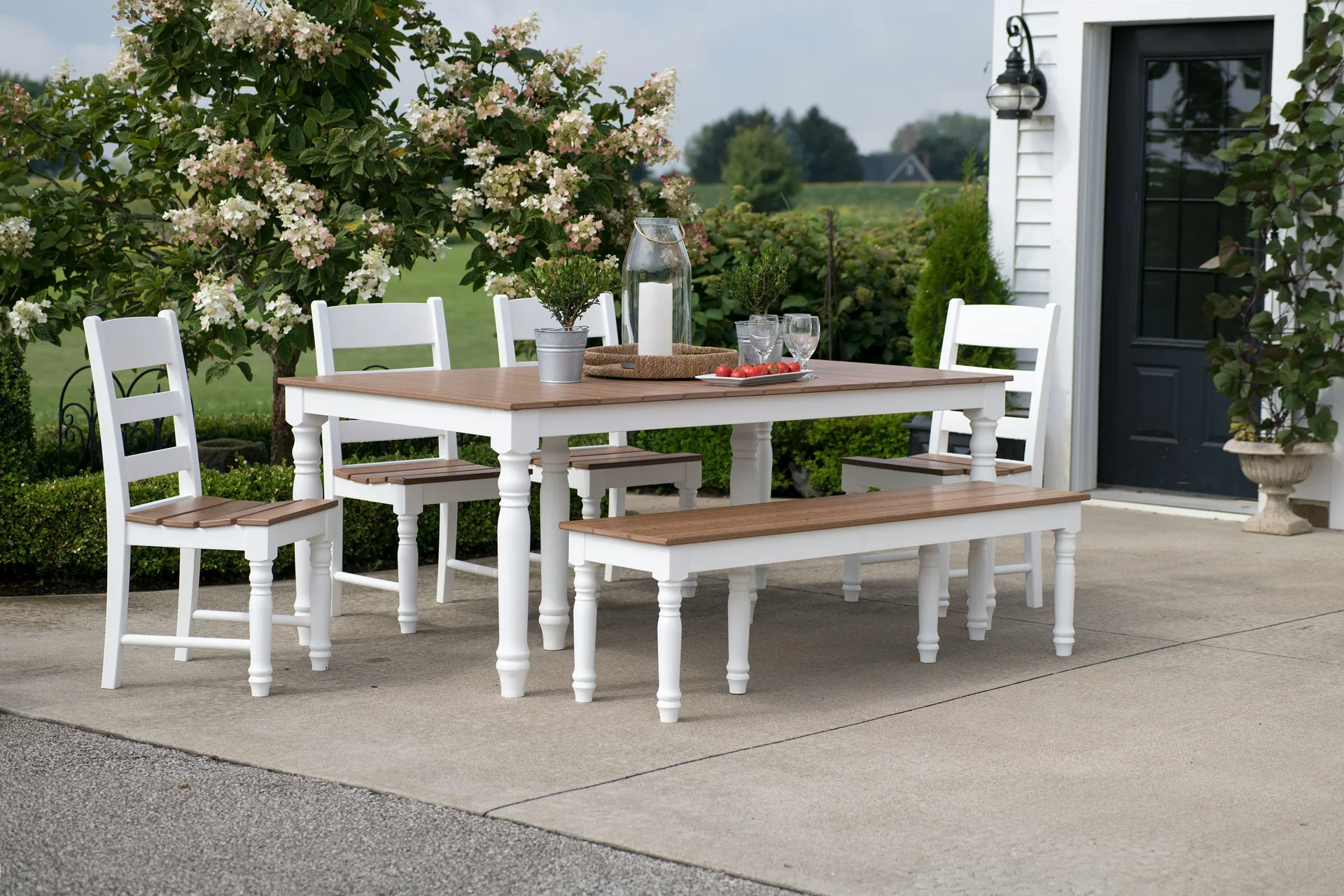 concrete patio with a dining table at a Oshawa farmhouse