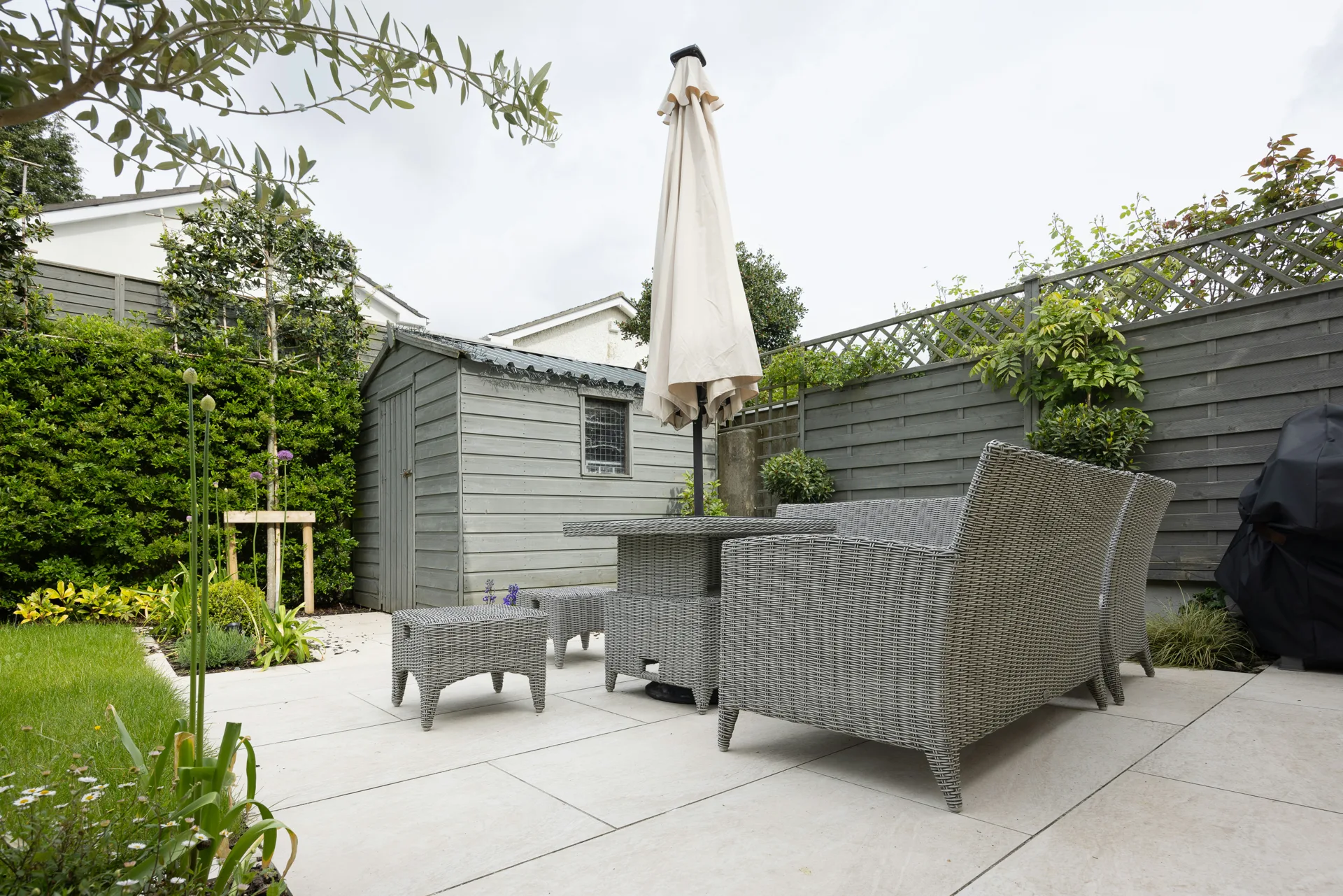 plain concrete patio in a Oshawa garden setting