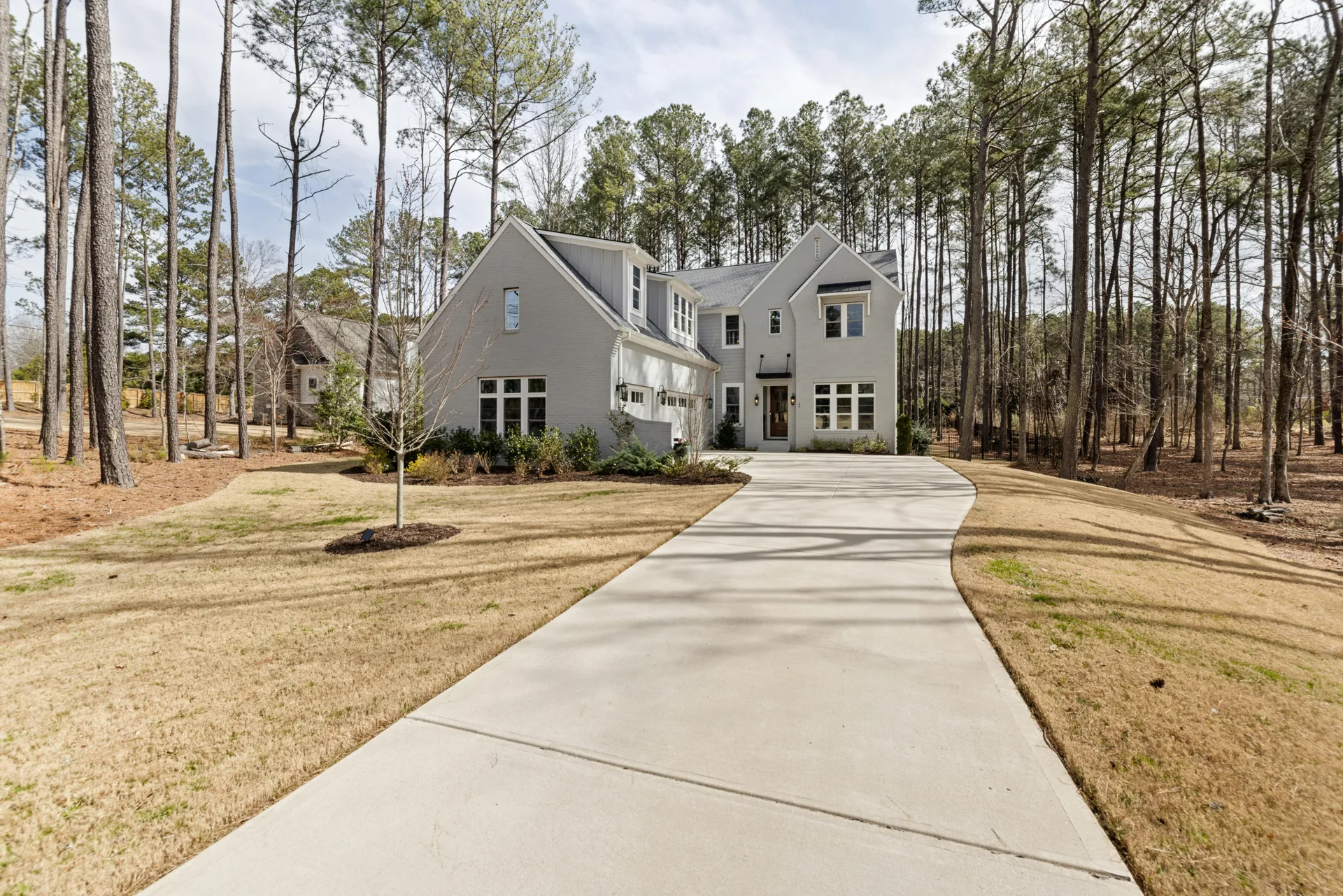 long curving concrete driveway through pines near Durham