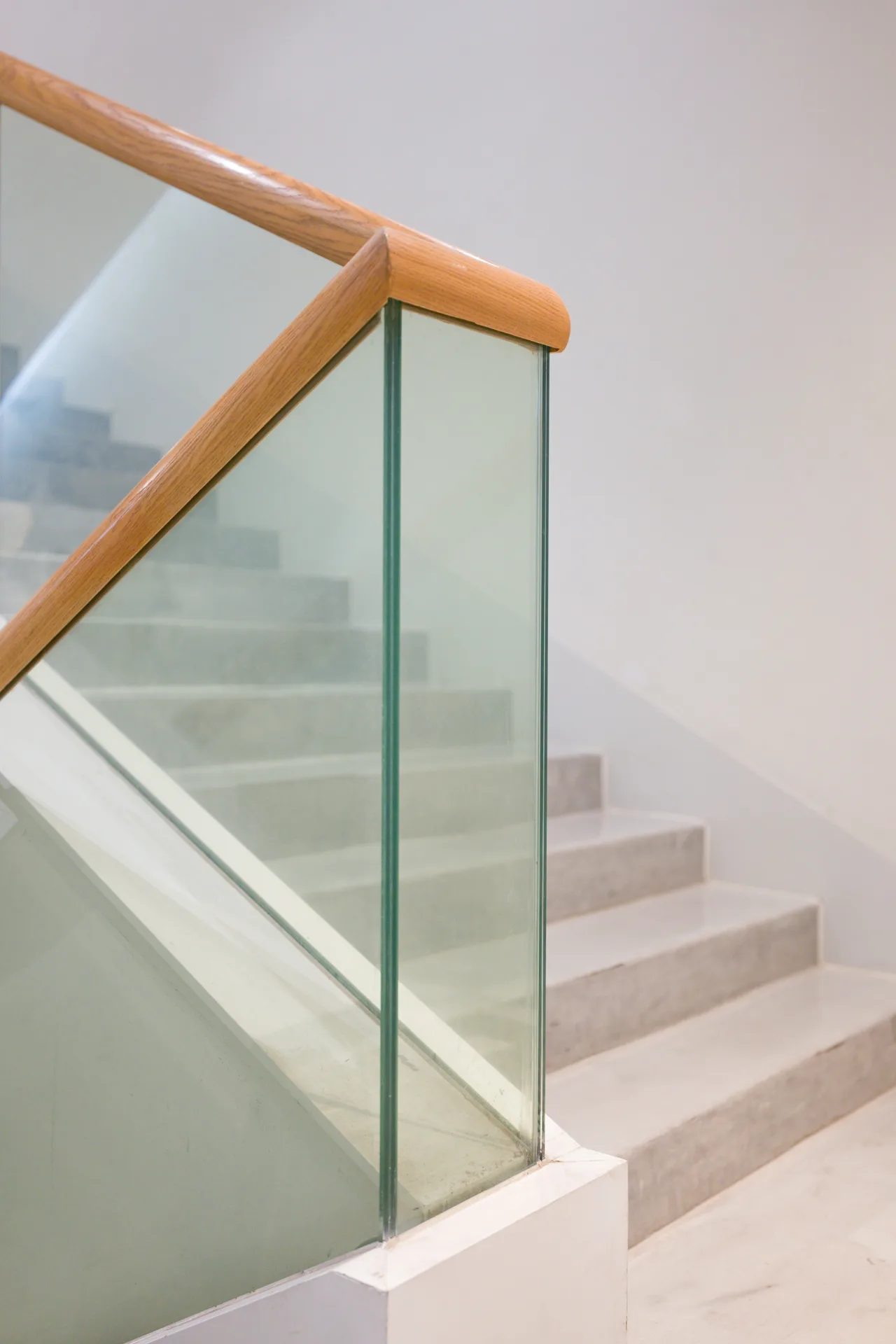 poured concrete staircase with glass railing at a Oshawa home